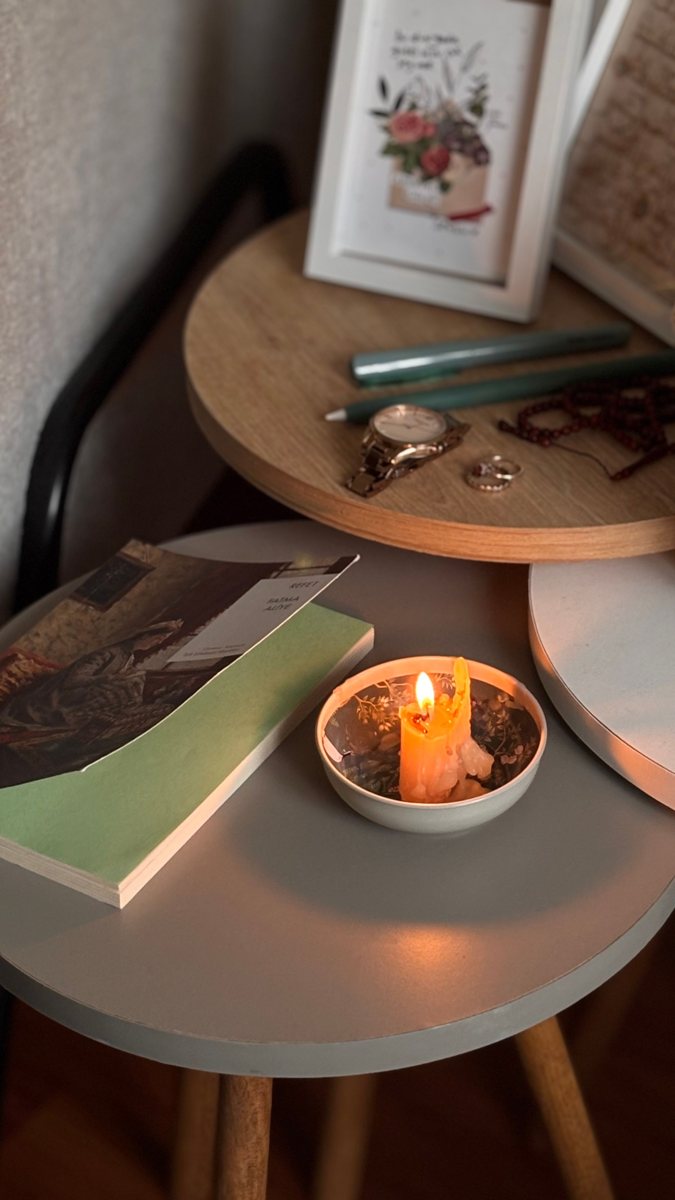 Lit candle and books in a cozy interior